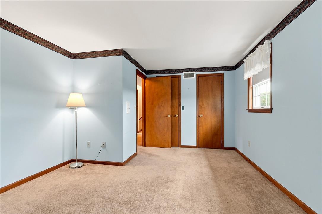 6090 Stone Post Road Bath, PA 18014 - Photo 33 of 57 A quiet bedroom with a soft carpet, ample natural light from the window, and solid wood doors offering warmth.