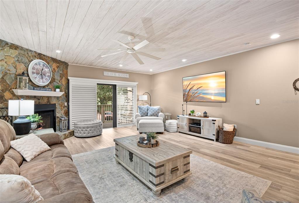 529 Sandy Hook Road Treasure Island, FL 33706 - Photo 10 of 55 a living room with furniture a fireplace and a flat screen tv