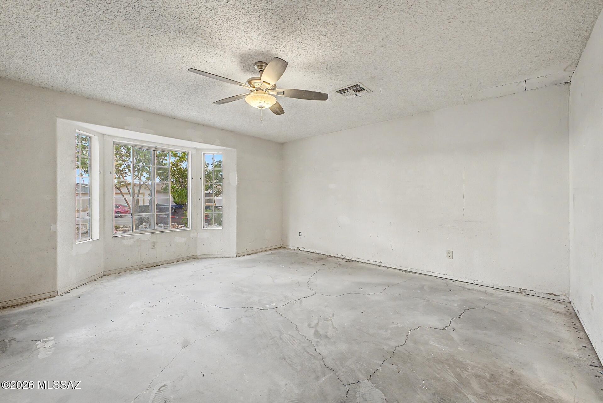 9810 East Stonehaven Way Tucson, AZ 85747 - Photo 17 of 27 a view of an empty room with a window