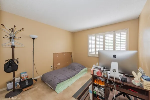 a bedroom with furniture and a window