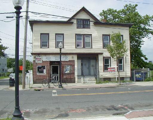 239 Newfield Avenue Bridgeport, CT 06607 - Photo 1 of 1 a front view of a house with garage