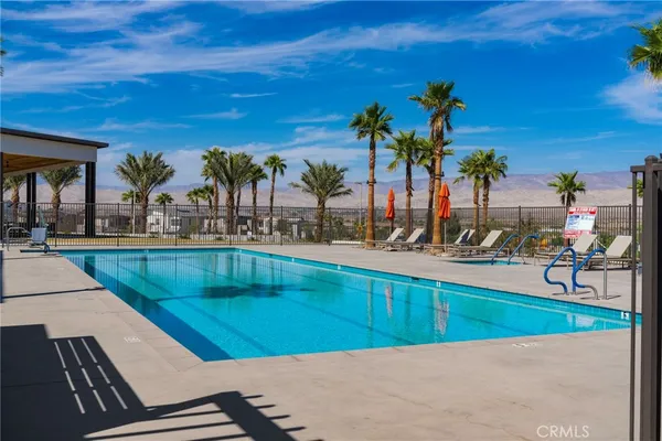 a view of a swimming pool with outdoor seating