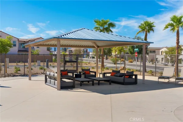 a view of a patio with a table and chairs under an umbrella