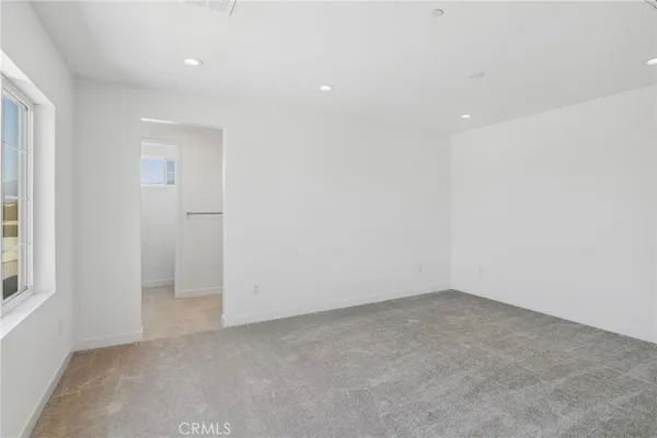 an empty room with a empty space and windows