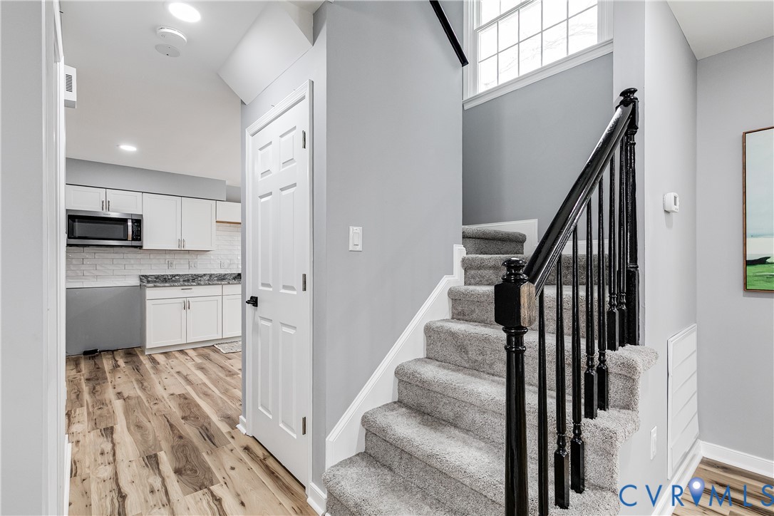 7112 Harbourside Court Midlothian, VA 23112 - Photo 11 of 49 a kitchen with white cabinets and appliances