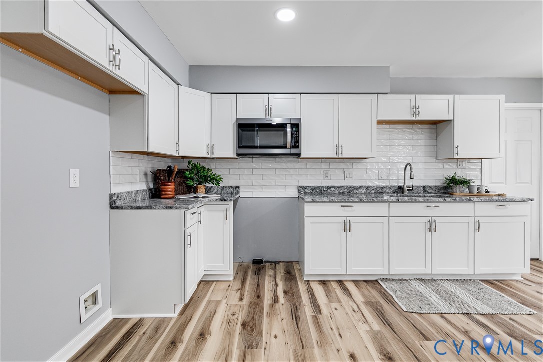 7112 Harbourside Court Midlothian, VA 23112 - Photo 19 of 49 a kitchen with white cabinets sink and stainless steel appliances