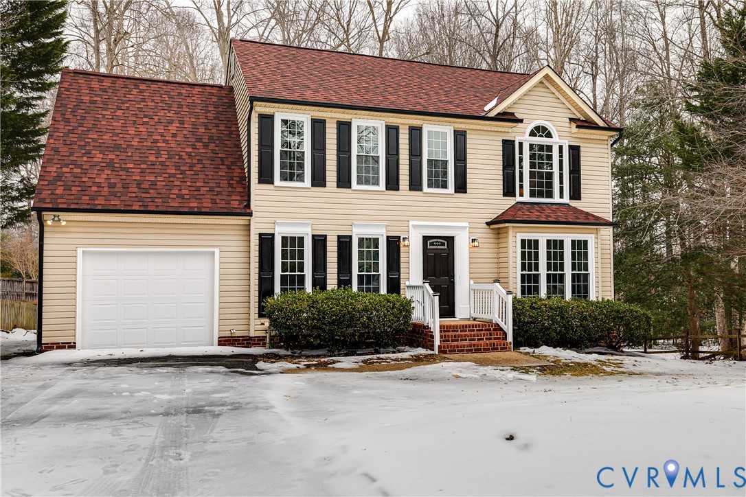 7112 Harbourside Court Midlothian, VA 23112 - Photo 2 of 49 a front view of a house with a yard and garage