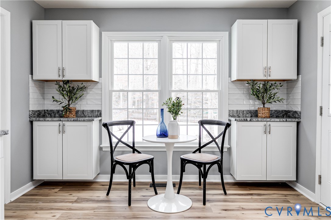 7112 Harbourside Court Midlothian, VA 23112 - Photo 21 of 49 a kitchen with stainless steel appliances a white table and chairs in it