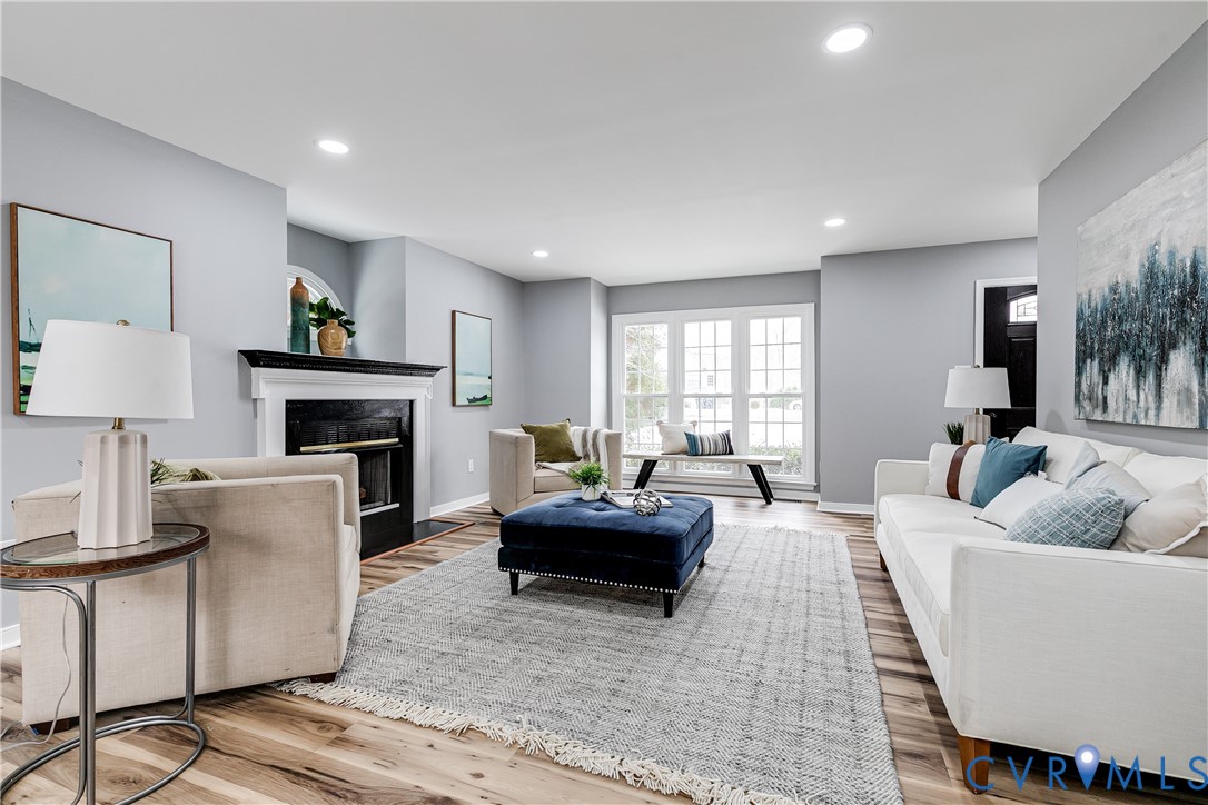 7112 Harbourside Court Midlothian, VA 23112 - Photo 8 of 49 a living room with furniture a fireplace and a large window