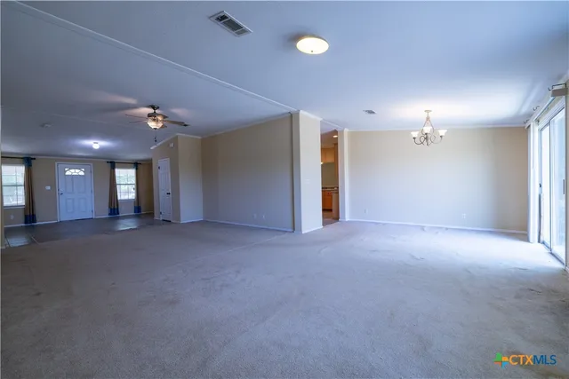 a view of a hallway with chandelier