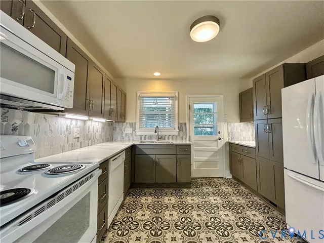 a kitchen with a sink stove and cabinets