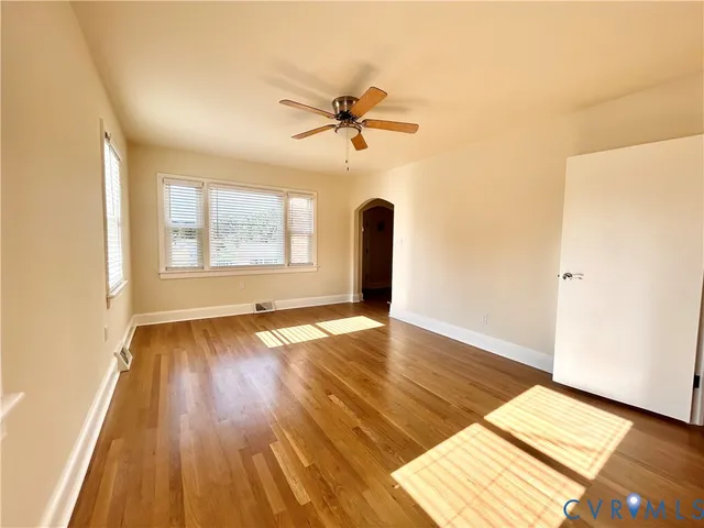 a view of a room with wooden floor and windows