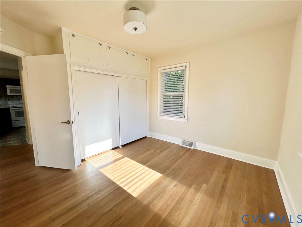 411 Hillcrest Avenue Colonial Heights, VA 23834 - Photo 21 of 33 a view of an empty room with wooden floor and a window