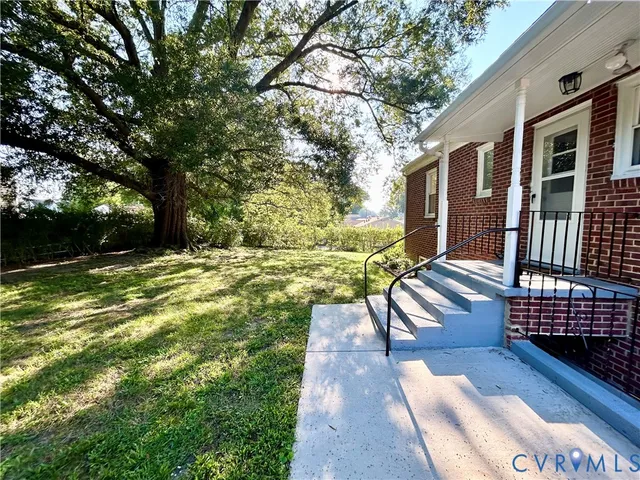 a porch with a bench next to yard