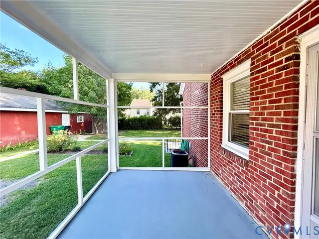 a view of a house with a yard from a porch