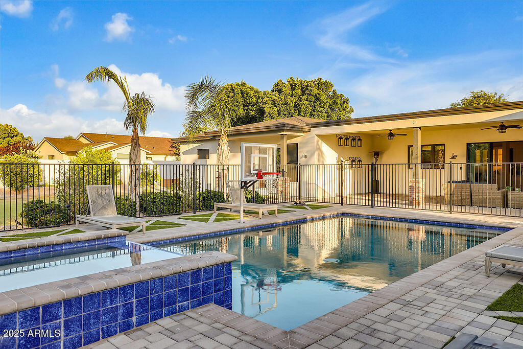 3924 East Roma Avenue Phoenix, AZ 85018 - Photo 22 of 32 a swimming pool with outdoor seating and yard in the back