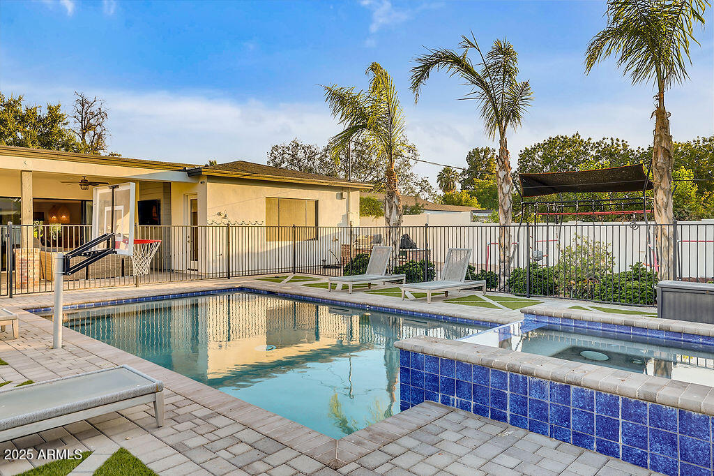3924 East Roma Avenue Phoenix, AZ 85018 - Photo 23 of 32 a view of a backyard with a swimming pool and furniture