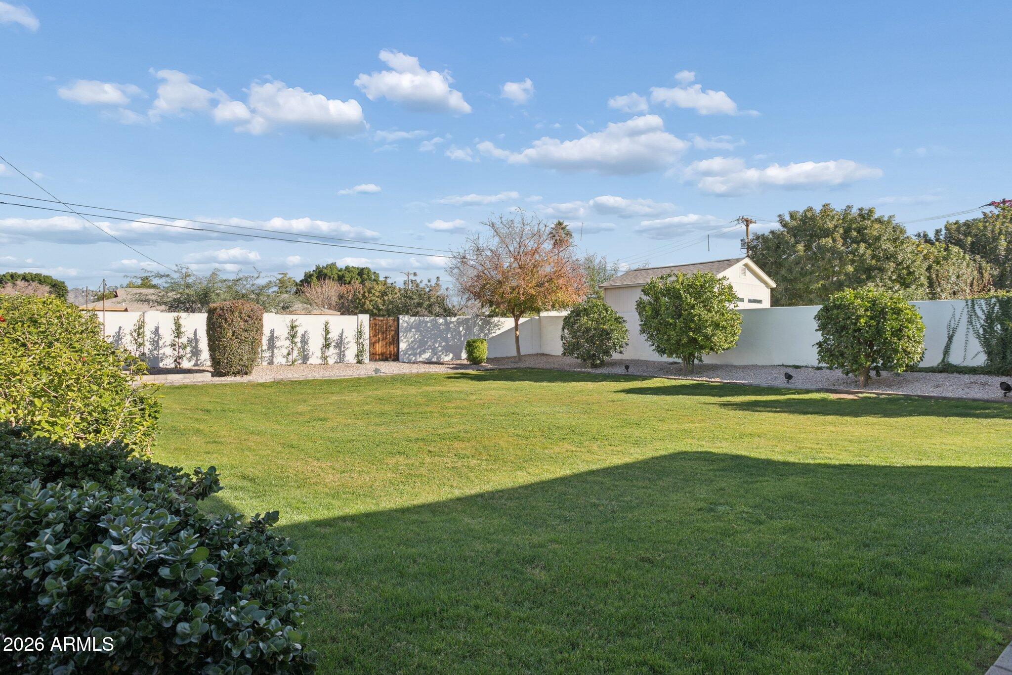 3924 East Roma Avenue Phoenix, AZ 85018 - Photo 25 of 32 a view of a house with a swimming pool and a yard