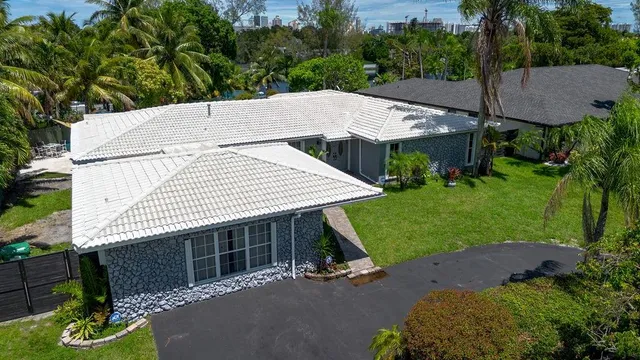 a view of a house with a yard and sitting area