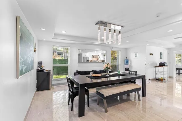 a open kitchen with stainless steel appliances granite countertop a refrigerator and a stove top oven