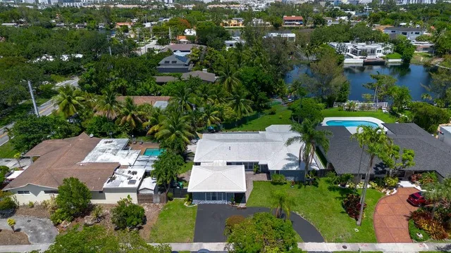 a view of a house with a yard and potted plants