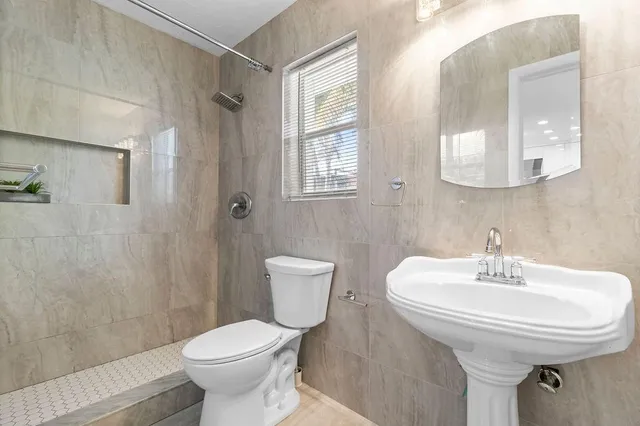 a spacious bedroom with a bed a table and a couch