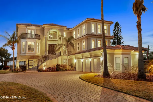 a living room with furniture a fireplace and a dining table with wooden floor