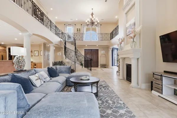 a spacious bedroom with a bed and a flat screen tv