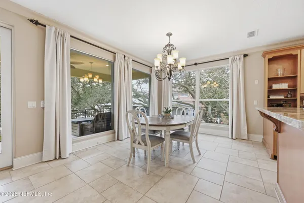 a view of a room with wooden floor swimming pool and windows