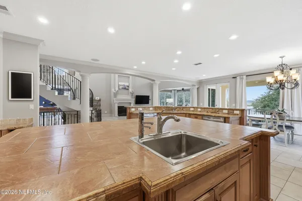 a bathroom with a granite countertop sink a mirror and a shower