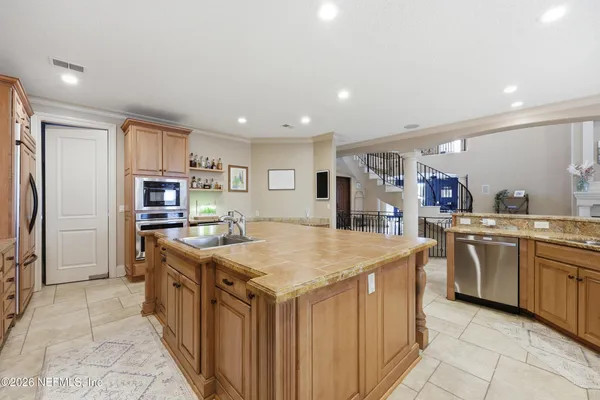 a spacious bathroom with a granite countertop sink a mirror and a shower