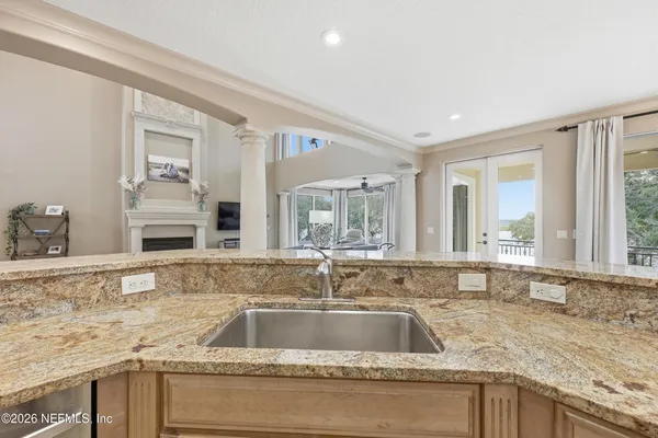 a spacious bedroom with a large bed and a chandelier