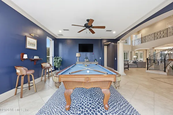 a front view of a house with a yard and palm trees