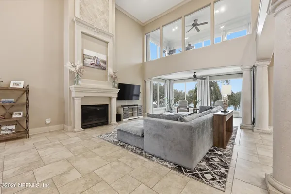 a living room with furniture a fireplace and a chandelier