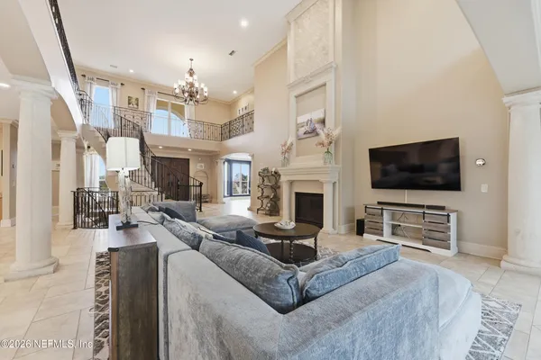 a living room with furniture a flat screen tv and a large window