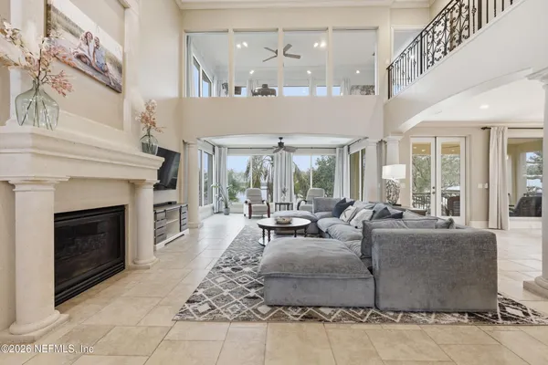 a living room with furniture ceiling fan and a window