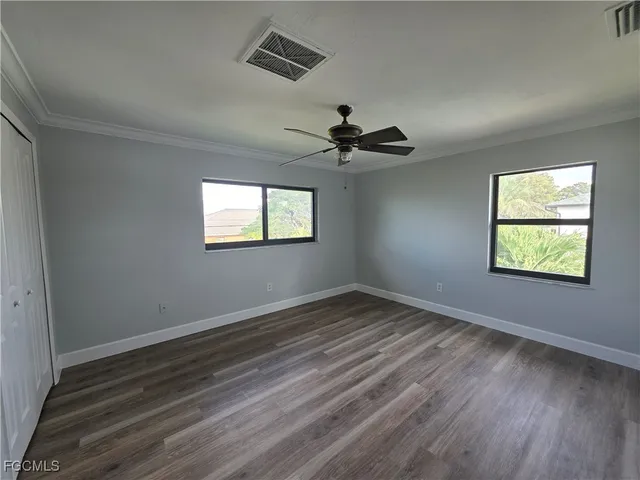 wooden floor in an empty room with a window