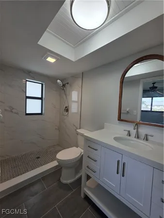 a bathroom with a double vanity sink toilet and a mirror