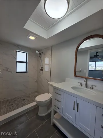 a bathroom with a double vanity sink toilet and a mirror