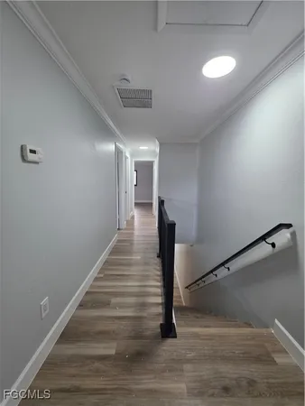 a view of entryway and hall with wooden floor