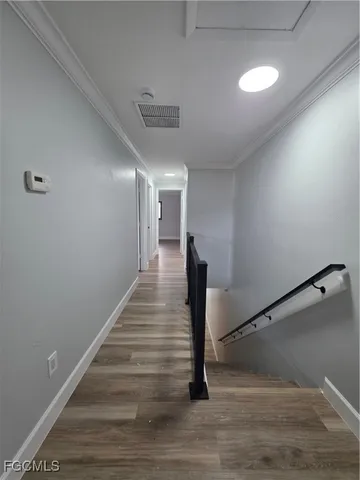 a view of entryway and hall with wooden floor