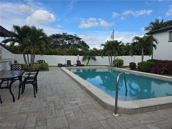 a view of a swimming pool with a lounge chairs
