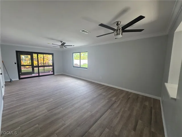 wooden floor in an empty room with a window