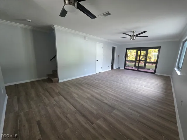 wooden floor in an empty room with a window