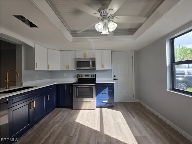 a kitchen with stainless steel appliances a stove sink microwave and cabinets