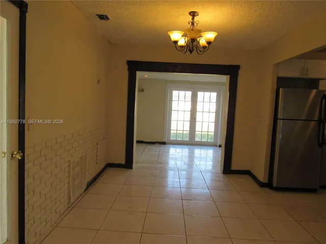 a view of a hallway with a chandelier