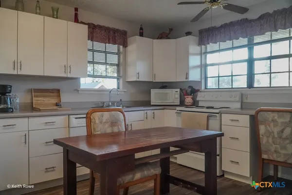 a kitchen with a sink cabinets and window