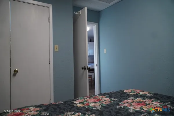 a bedroom with a bed and pillows