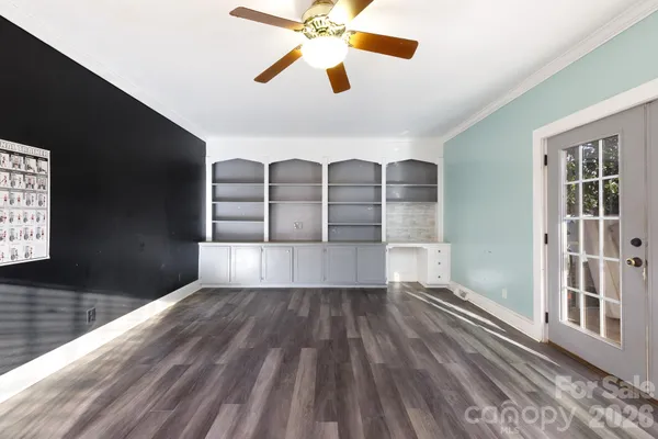 a view of a ceiling fan and wooden floor
