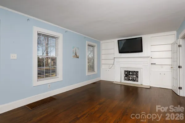 a living room with a flat screen tv and a fireplace